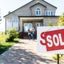 sold house with blurred family on background