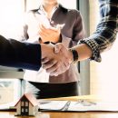 Real estate agent and customers shaking hands together celebrating finished contract after about home insurance and investment loan, handshake and successful deal